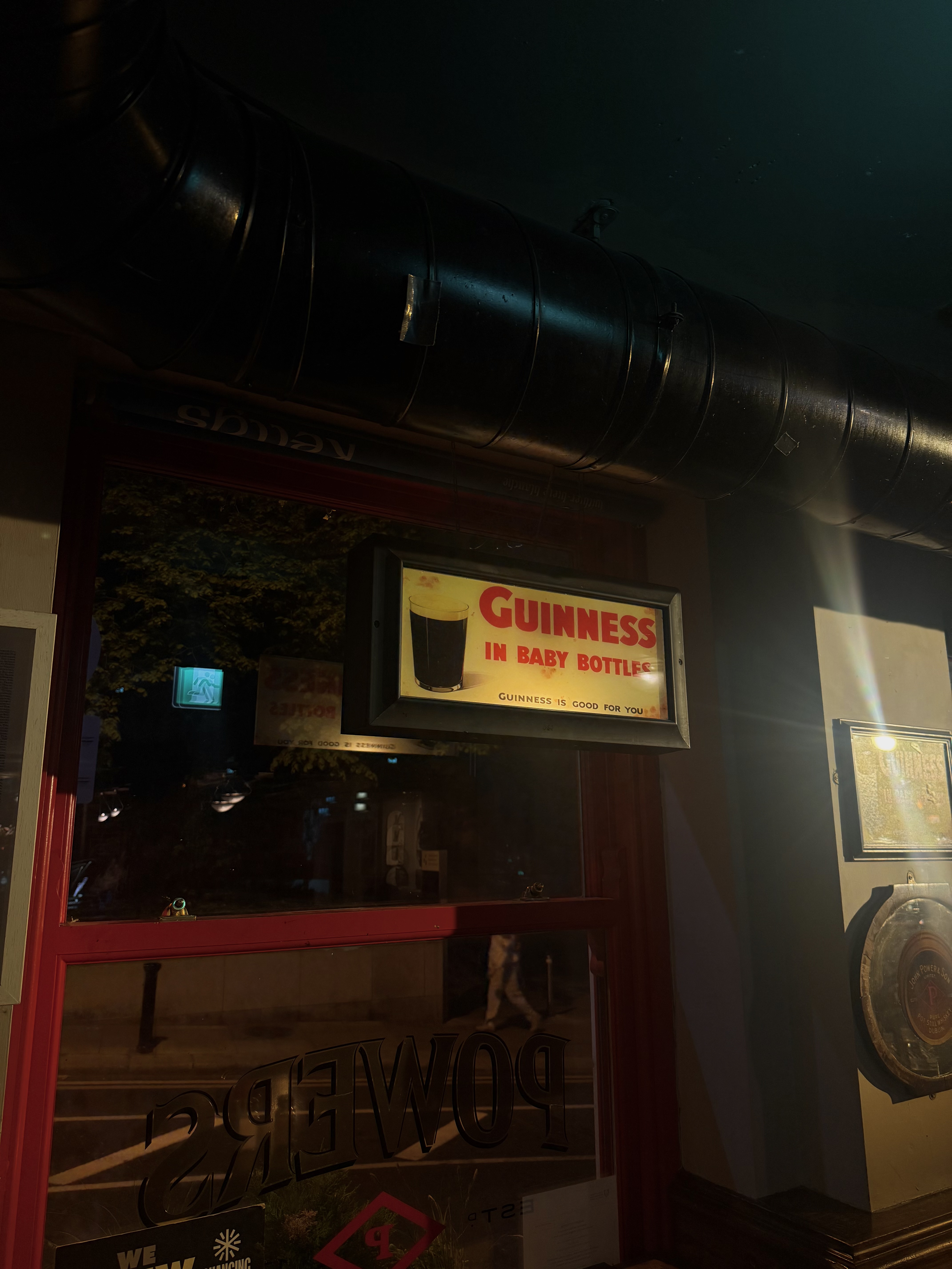 A sign saying 'guinness in baby bottles'