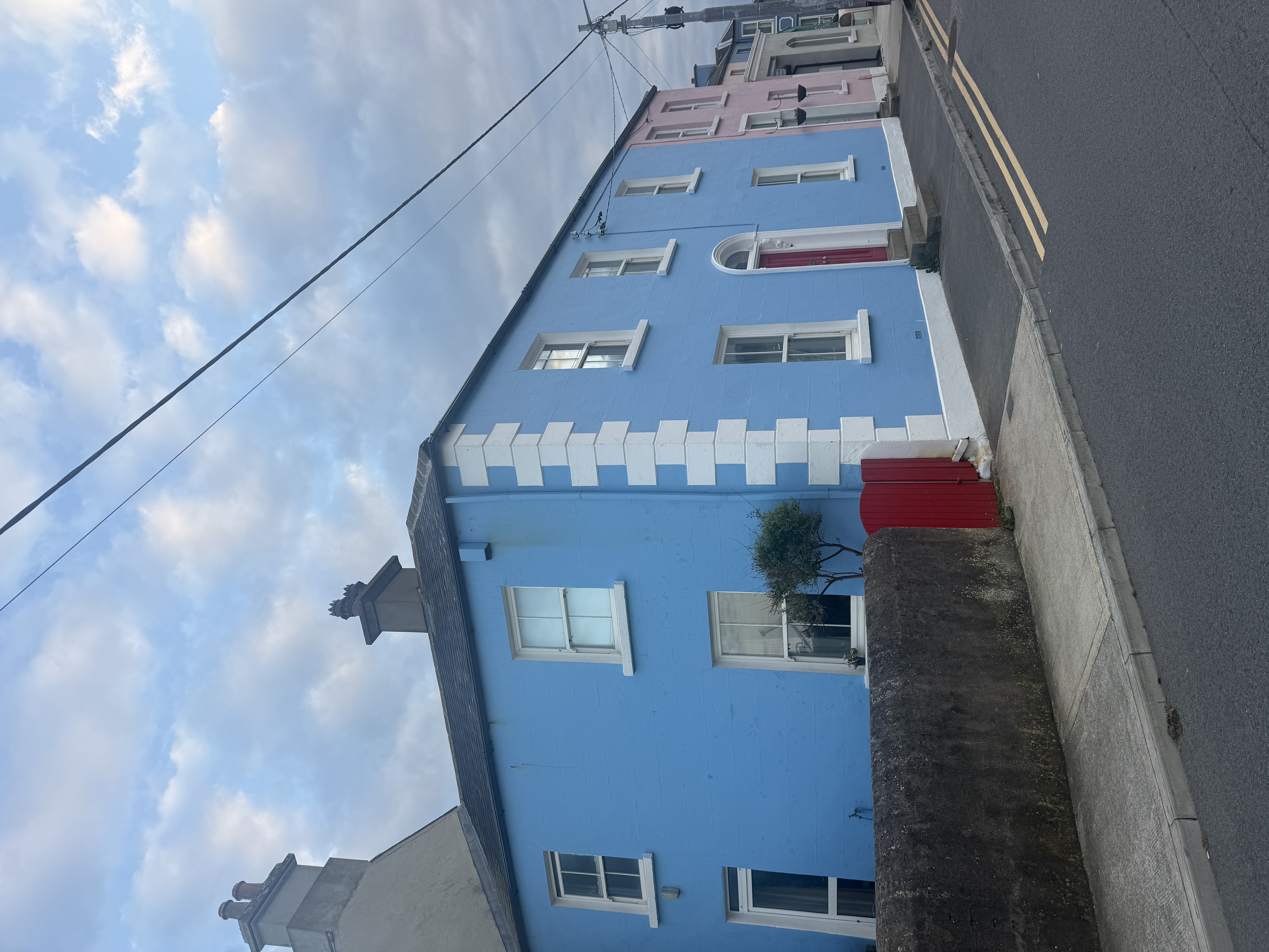 A pink and blue house next to each other