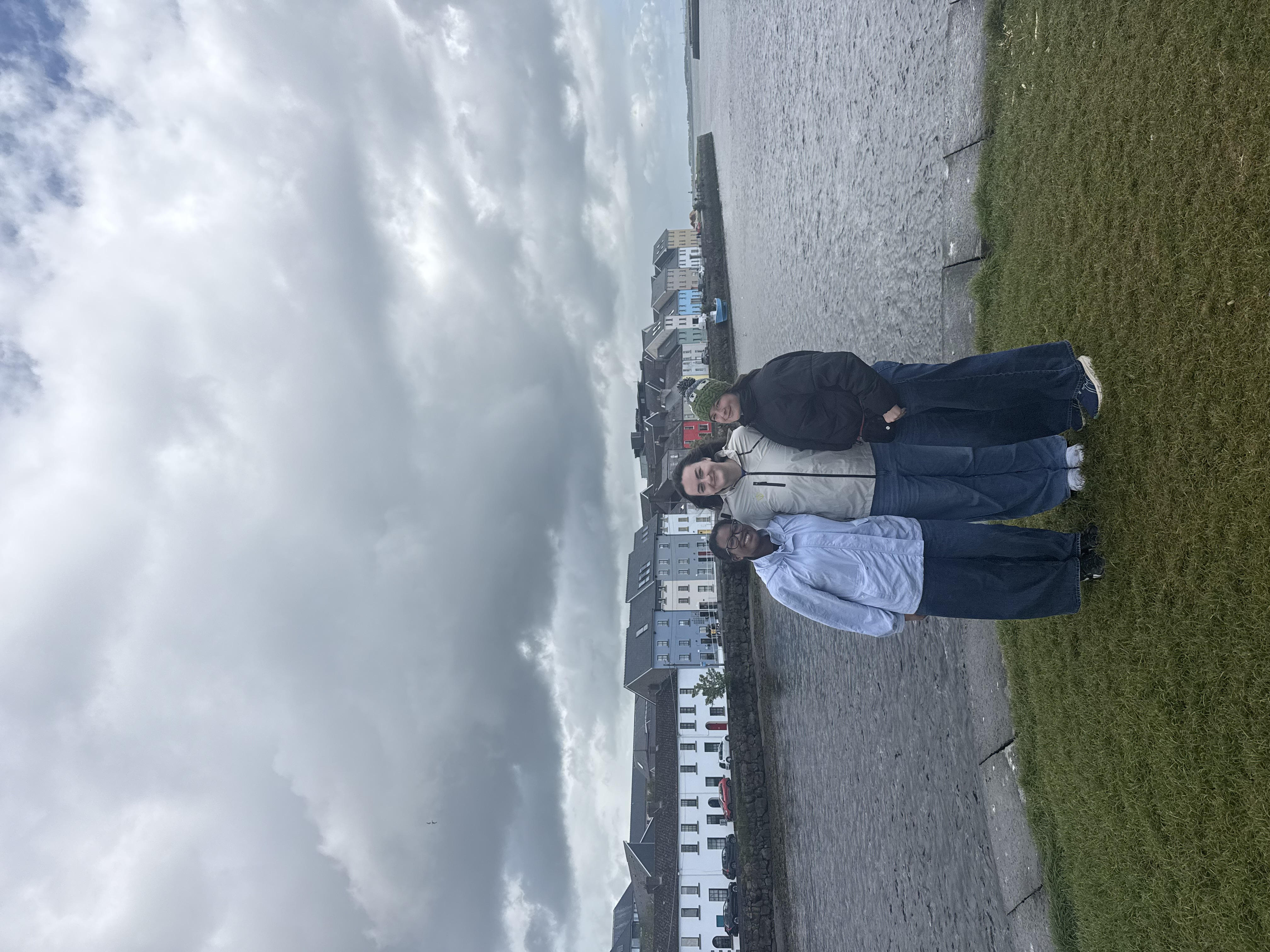 group of 3 in front of river