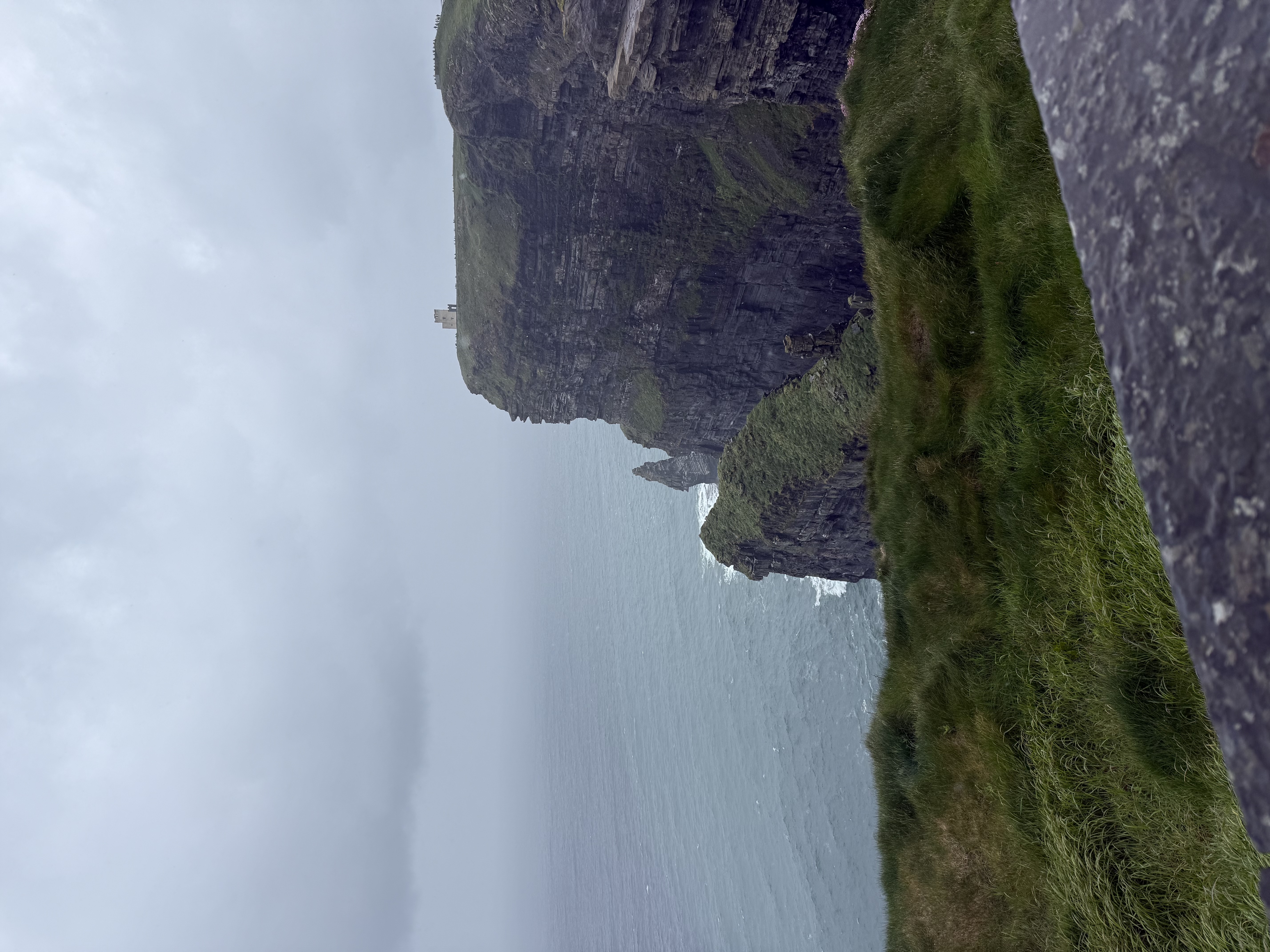 Steep green and grey cliffs by the ocean