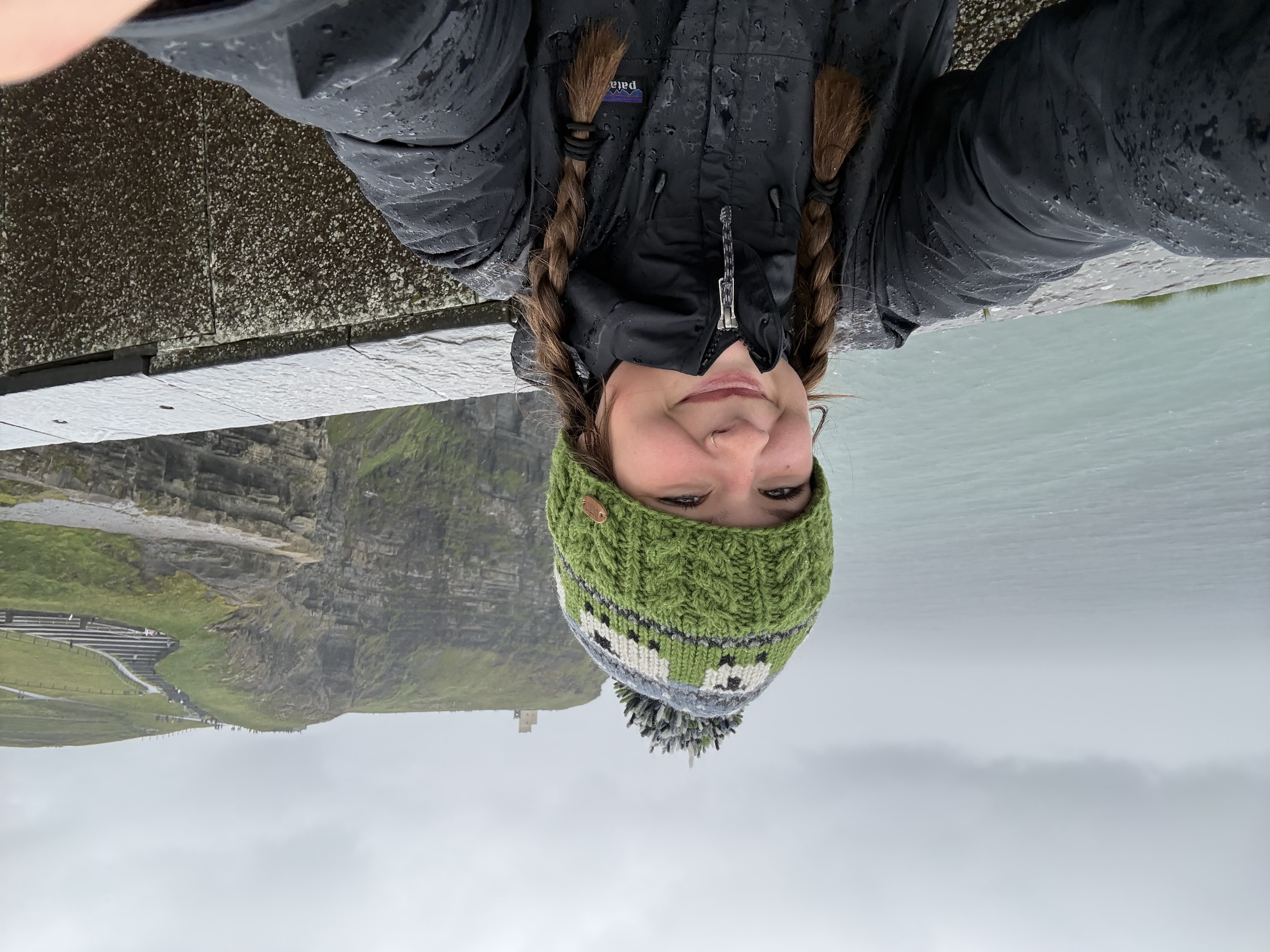 mia taking a selfie in front of cliffs