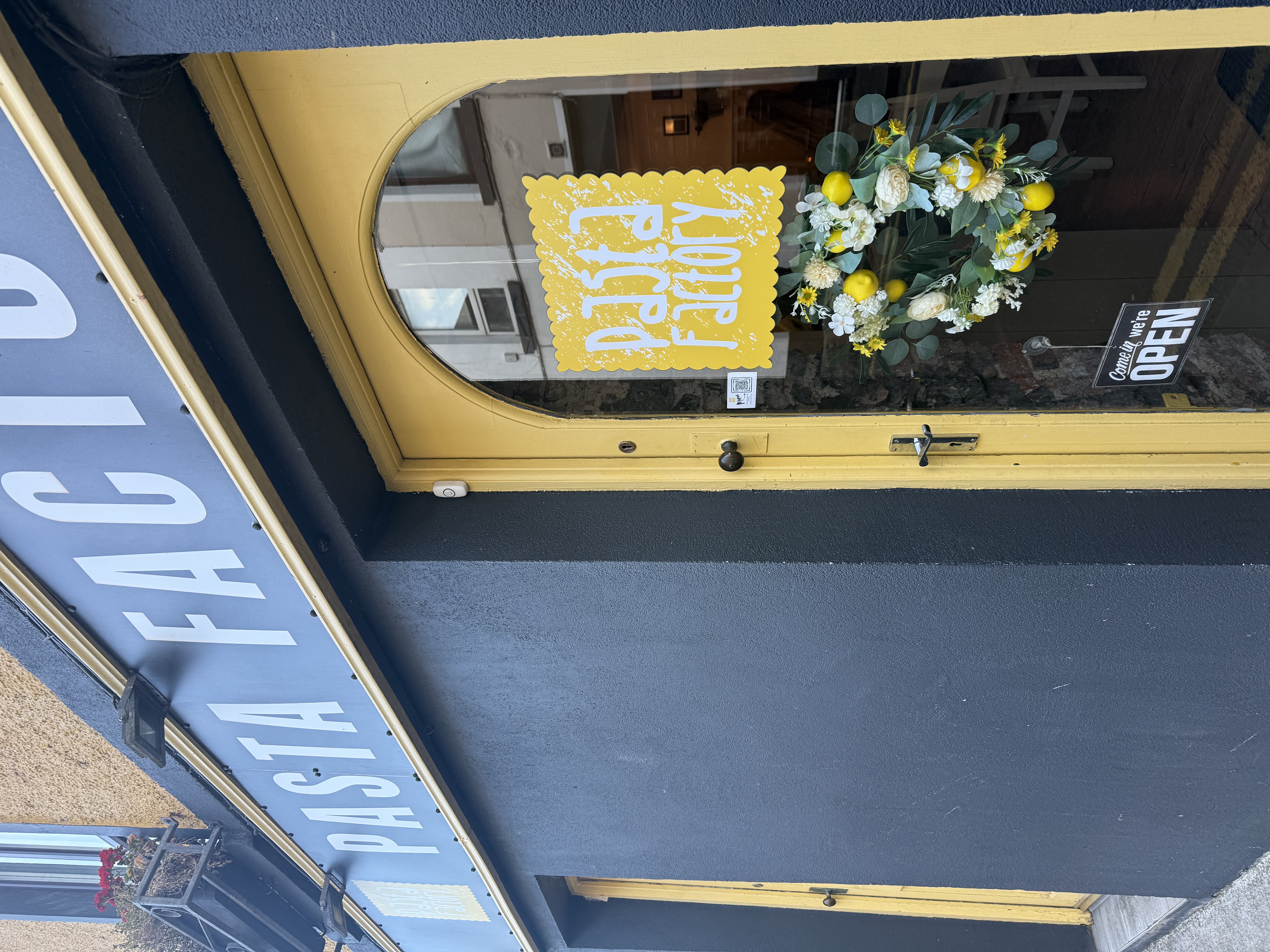 outside of restaurant with yellow arch door