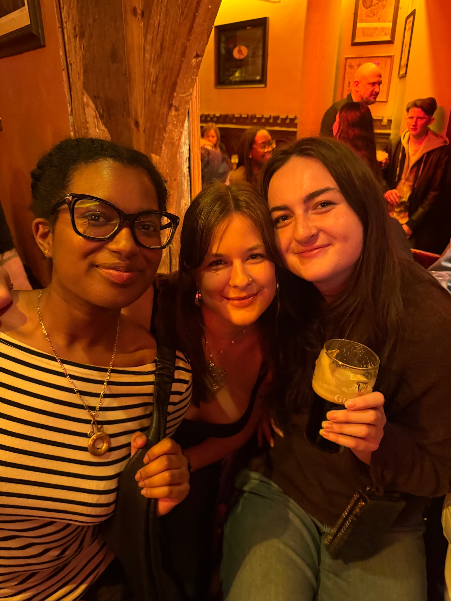 Group of three girls with a guinness glass