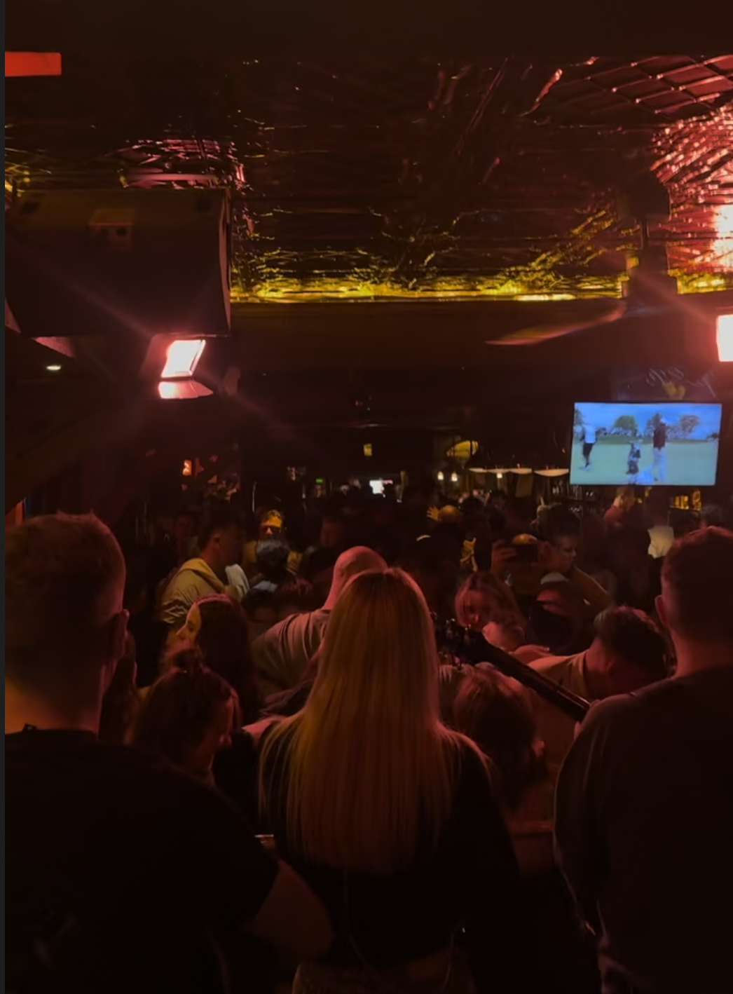 large crowd of people in pub