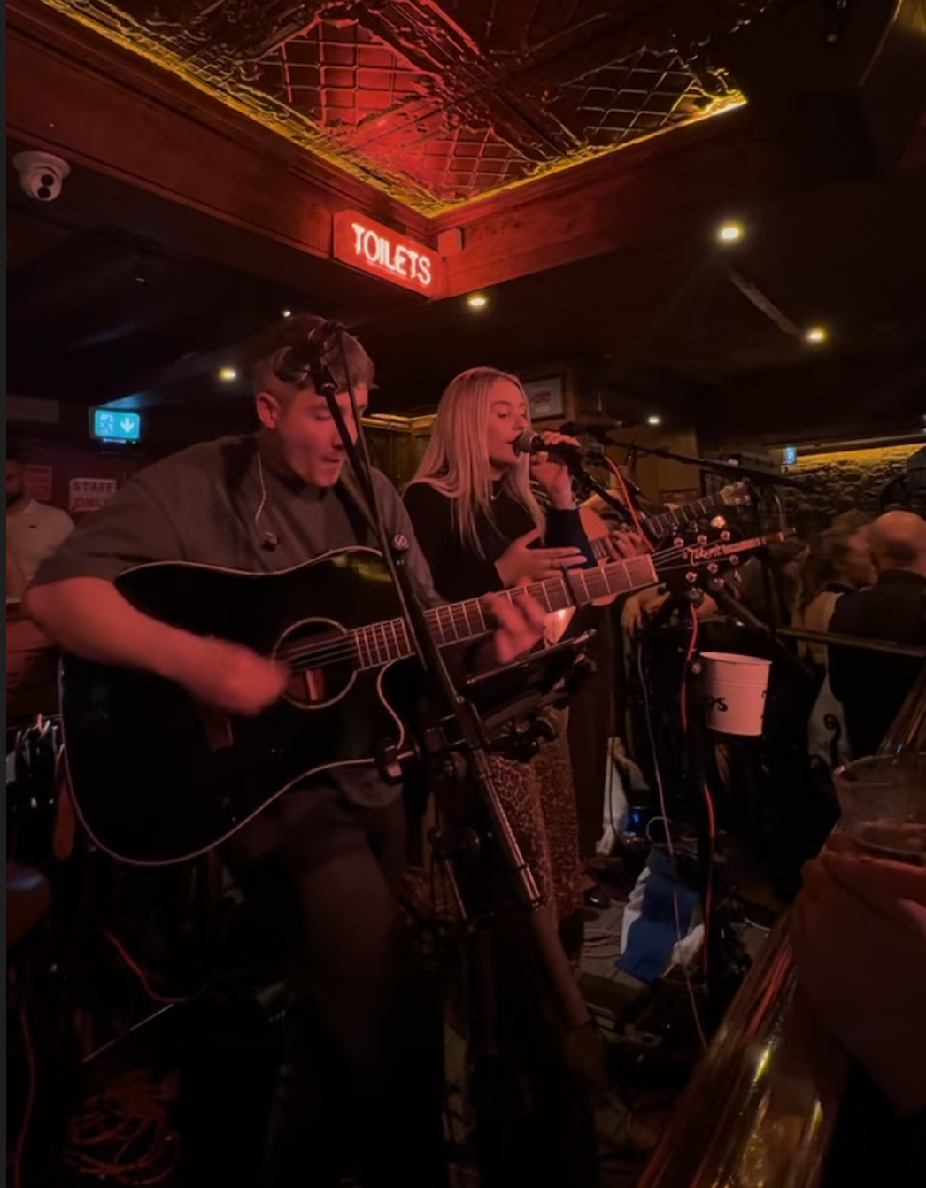 Two singers, one with a guitar
