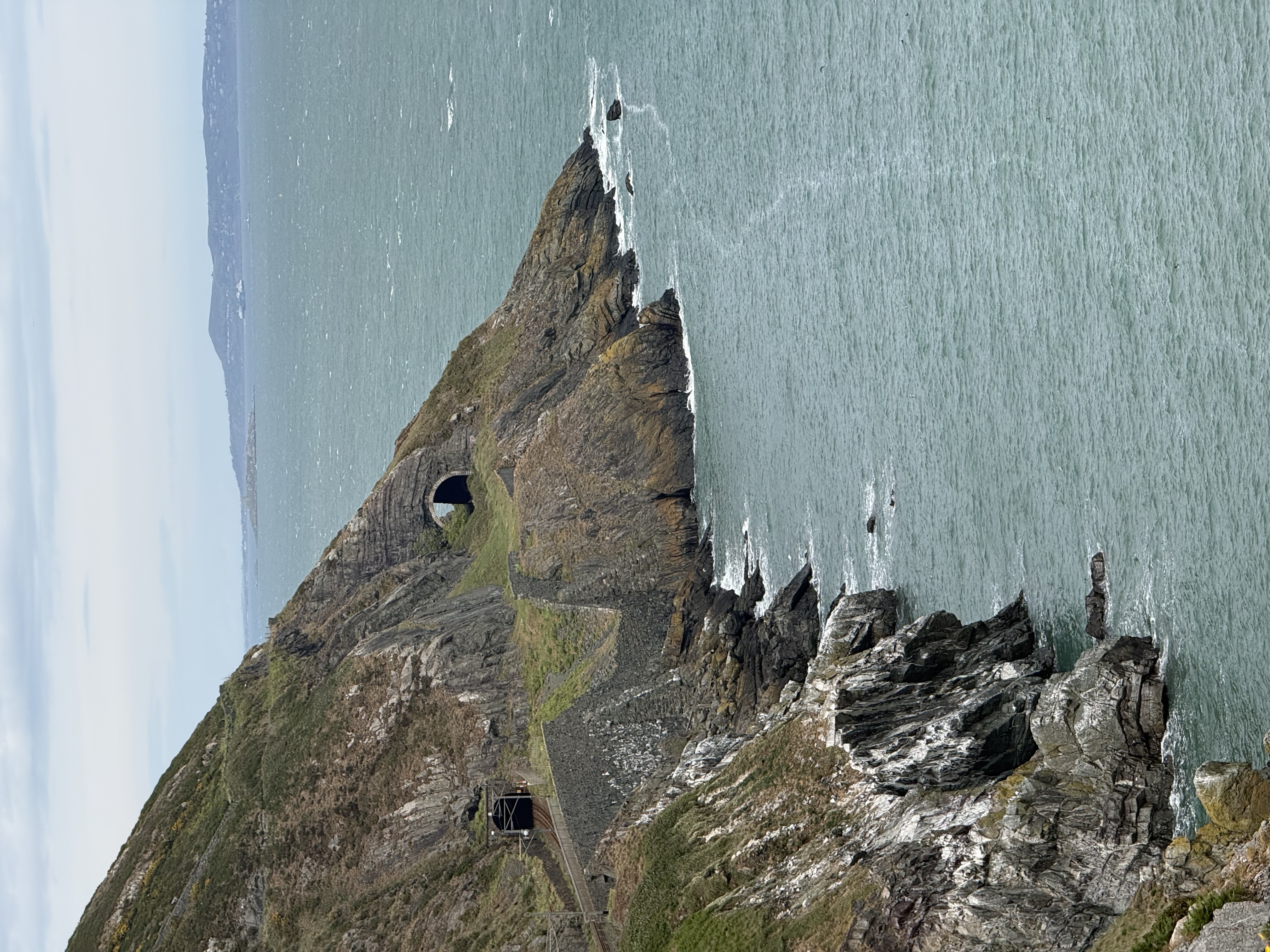 cliffs into the ocean with a train track