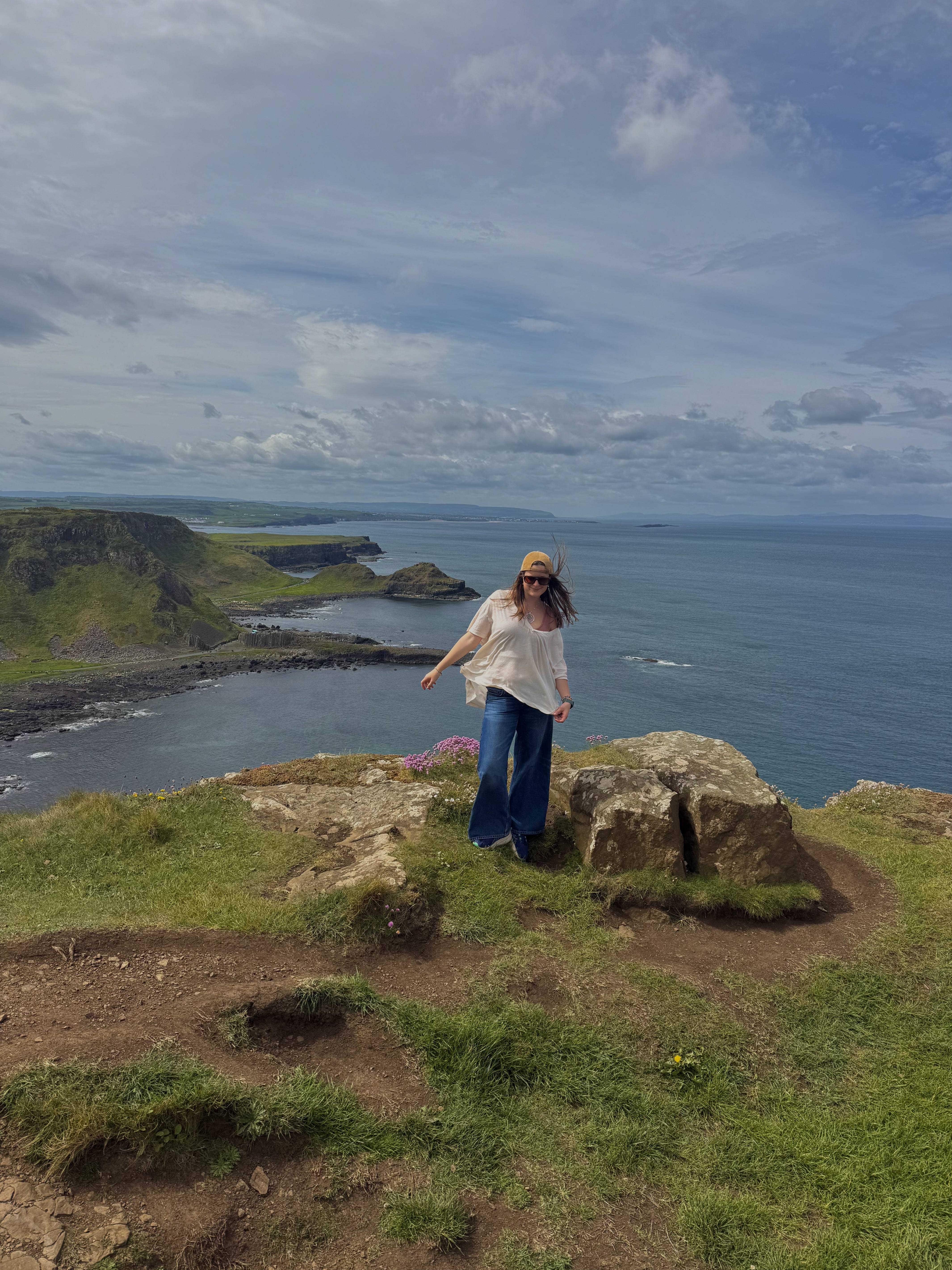 Mia standing in front of a cliff and the ocean